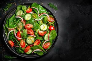 Healthy green salad with fresh tomato, cucumber, red onion and lettuce in bowl on dark stone background. Top view. generative ai. photo