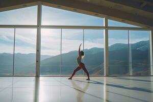 young beautiful woman doing yoga in a modern bright room with large windows at sunny day. Yoga at home concept. photo