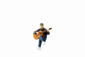 Miniature Musician with guitar isolated on white background with clipping path photo