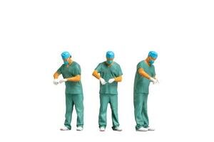 Miniature people young doctor in scrubs Isolated on white background with clipping path photo