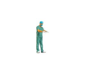 Miniature people young doctor in scrubs Isolated on white background with clipping path photo