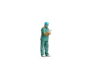 Miniature people Full length portrait of young doctor in scrubs Isolated on white background with clipping path photo
