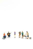 Miniature people are making barbeque, drinking beverages isolated on white background photo