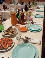 Glassware on a served table in a restaurant lined up perspective photo