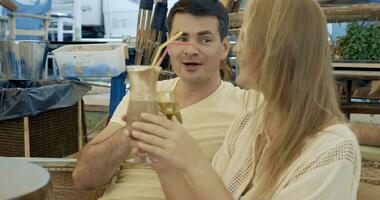 Young couple having coffee cocktails in cafe video