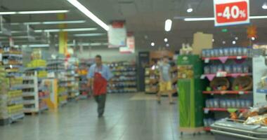 Defocus of people shopping in supermarket video