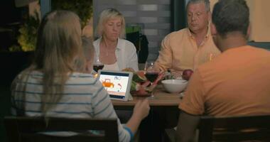 Friendly family having late outdoor dinner video