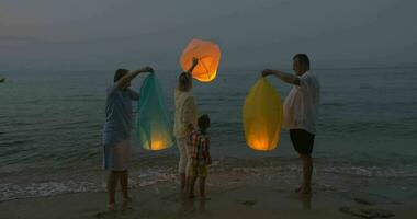 familj flygande himmel lykta på de strand video