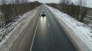 Aerial shot of minivan on winter road video