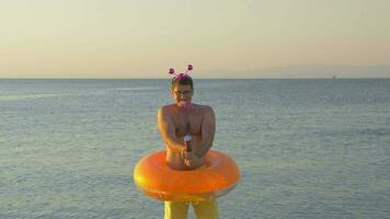 Man with confetti cracker at the seaside video