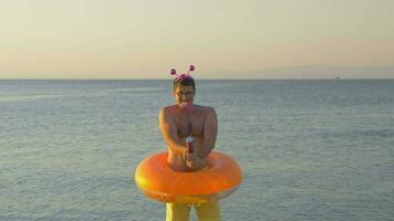 Man with confetti cracker at the seaside video