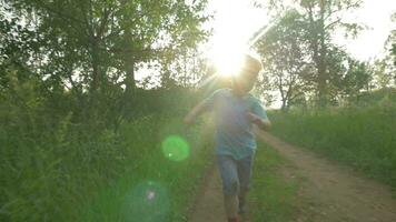 Happy child running in the woods at sunset video