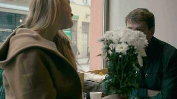 Loving couple looking at each other in cafe video