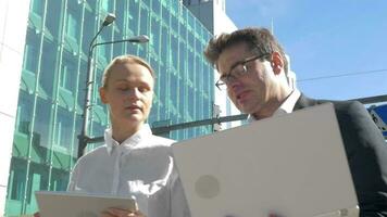 Busy businesspeople with electronics in the city video