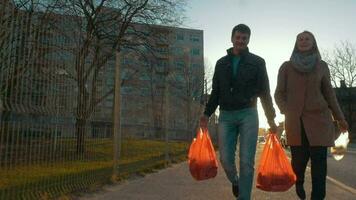 Man and woman returning home after shopping video