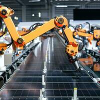 Industrial robot arms are producing solar panels in large factories. photo