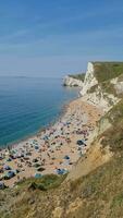 Most Beautiful High Angle View of British Landscape and Sea View of Durdle Door Beach of England Great Britain, UK. Image Was captured with Drone's camera on September 9th, 2023 video