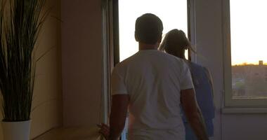 Man and woman looking at the city from balcony video