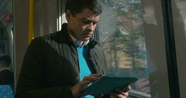 Man with touch pad traveling by train video