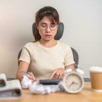 stressed Woman with mistake paper and clock, Tired female businesswoman working overload at office, Exhausted woman with document folder stack at late night in home. Failure, Problem and business photo