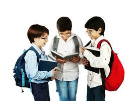 Three cute schoolboys read books photo