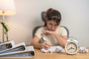 stressed Woman with mistake paper and clock, Tired female businesswoman working overload at office, Exhausted woman with document folder stack at late night in home. Failure, Problem and business photo