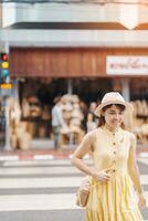 Young asian woman traveler in dress with hat traveling to wicker shop on Chang Moi Kao Road, Tourist visit at the old city in Chang Mai, Thailand. Asia Travel, Vacation and summer holiday concept photo