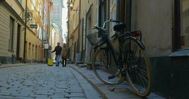 Man and woman with travel bag wandering in old city street video