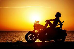 Woman biker enjoying sunset photo