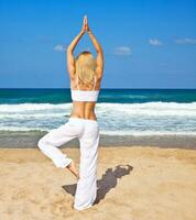 Healthy yoga exercise on the beach photo