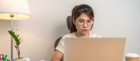 stressed Asian Woman using laptop, Tired female businesswoman working overload with headache and Sleepy at office, Exhausted casual woman with computer at late night in home. Work Life Balance concept photo