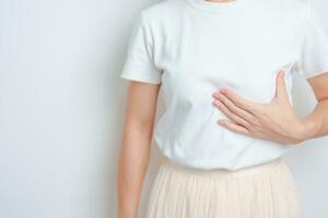 Woman having Breast pain and Check Body Chest. Pink October Breast Cancer Awareness month, National cancer survivors month, Mother, World cancer day and Health diagnosis concept photo