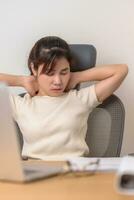 Woman having Neck and Shoulder pain during work long time on workplace. due to fibromyalgia, rheumatism, Scapular pain, office syndrome, stretching and ergonomic concept photo
