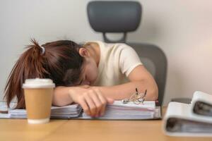 Stressed Asian woman having Tired and Sleepy while working, female businesswoman having headache at office, Exhausted woman with documents folder stack at home late night. Overworked and Overtime photo