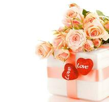 Beautiful roses with gift box and hearts photo