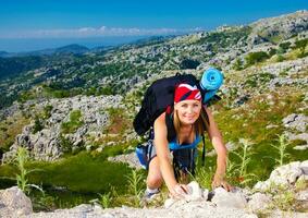 Teen girl climb on mountain photo