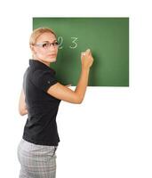 Teacher writting on chalkboard photo