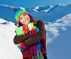 Happy girl with Christmas gift, winter outdoor portrait photo