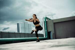 Young woman streching muscles before exercises outdoors. photo