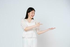 Happy young woman presenting or showing open hand palm with copy space for product isolated on white background. photo