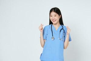 Smiling woman doctor showing mini heart sign isolated on white background. photo