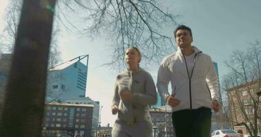 Young people keeping fit with outdoor run video