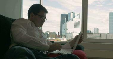 Businessman Resting on the Couch with Laptop video