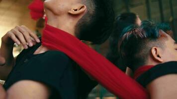 a group of Asian dancers dance with red cloth ties around their bodies video