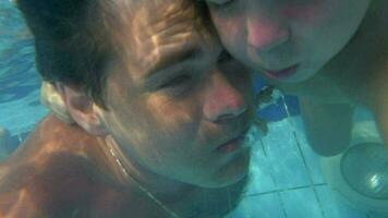 Father and son diving together in the pool video