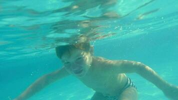 Boy Swimming Underwater in Swimming Pool video