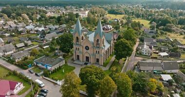 aerial view and flyby over old yellow  bricks neo gothic temple or catholic church in countryside video