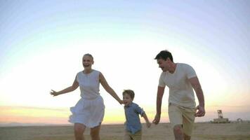 Parents having happy time with child on the beach video