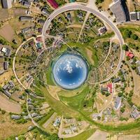 blue sphere inside overlooking old town, urban development, historic buildings and crossroads with cars. Transformation of spherical 360 panorama in abstract aerial view. photo