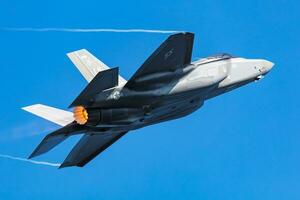 US Air Force USAF Lockheed F-35 Lightning II stealth fighter jet plane flying. Aviation and military aircraft. photo